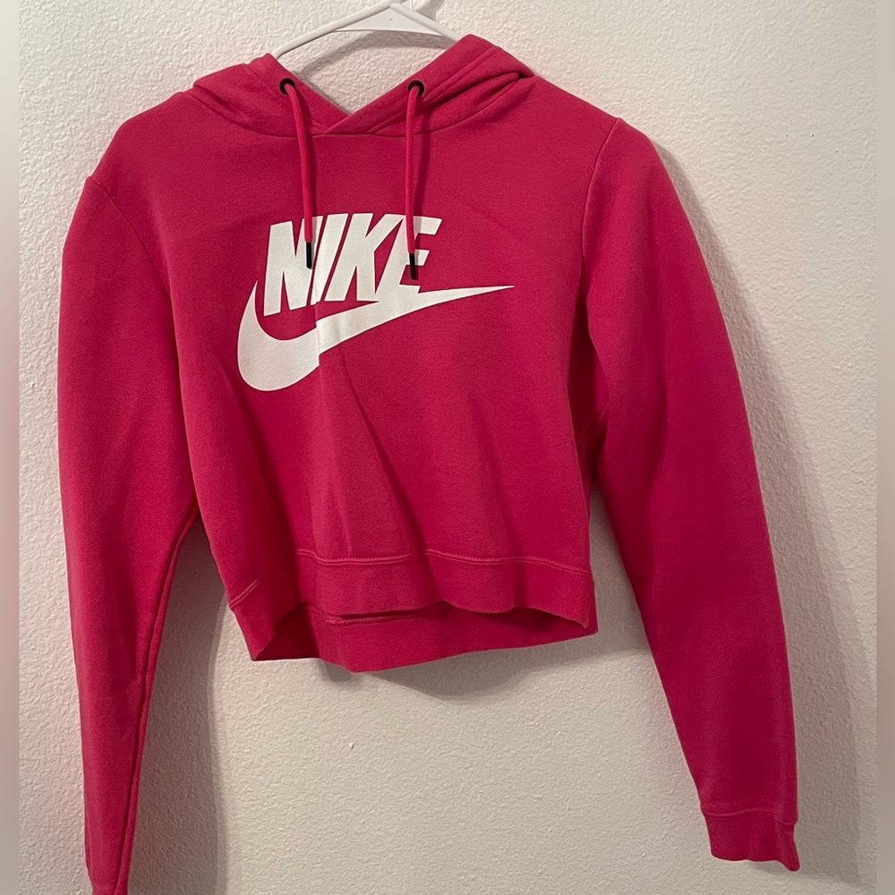 This is a hot pink Nike crop top hoodie